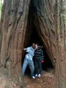 Rebecca and Lani in a tree. Looks like he's holding the tree open for her.